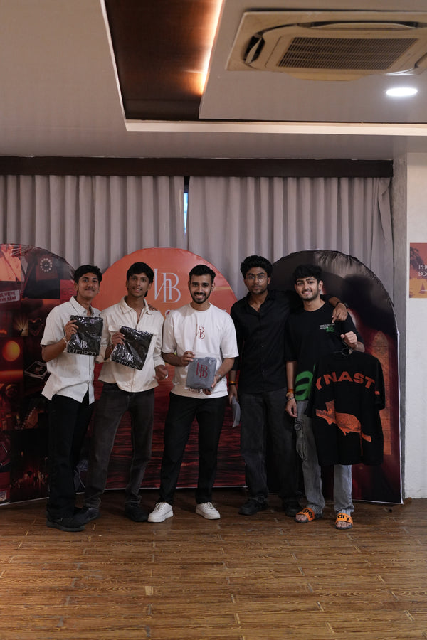 Real Hallberd customers holding oversized 
graphic t-shirt packaging — Legacy Line community 
event India